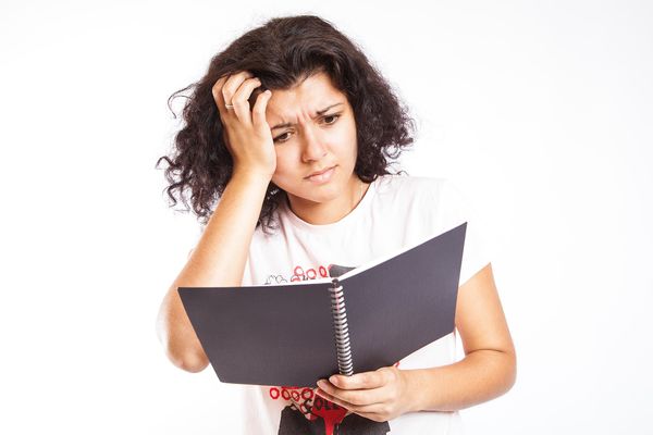 Confused your woman staring at a book.